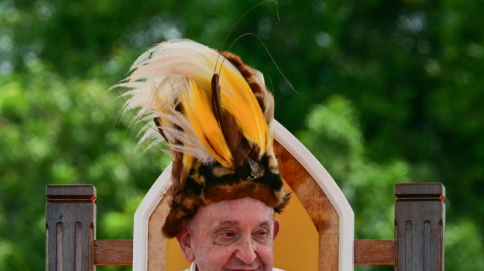 Sporting a feathered headdress, Pope finds 'Eden' in Papua New Guinea